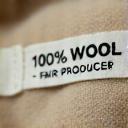 Close-up Stofflabel: '100% Wolle – Fair produziert'